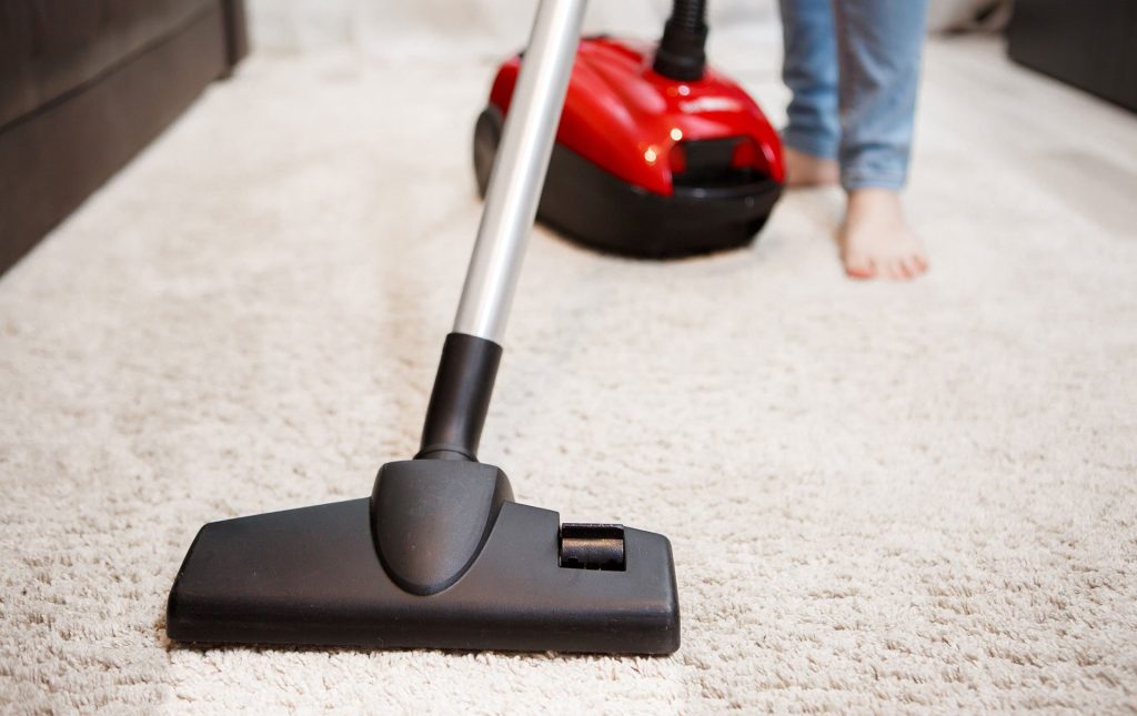Vacuuming with red vacuum